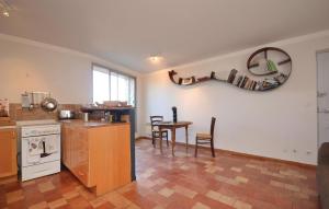 a kitchen with a counter and a table with chairs at Cozy Apartment In Bonnieux With Kitchen in Bonnieux