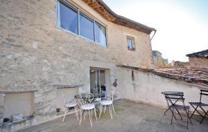 a patio with chairs and a table in front of a building at Cozy Apartment In Bonnieux With Kitchen in Bonnieux +8 photos