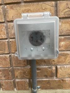 a metal box on the side of a brick wall at Utah Valley Retreat - Luxurious Self check-in Apt, UVU BYU, EV Charge in Orem