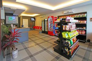 a grocery store aisle with soda machines and food at Dream City in Kuching