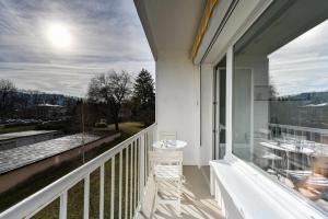 uma varanda com uma mesa e cadeiras e uma vista em Le Boileau - Apartment for 4 people parking and balcony CLOSE to the Lake em Annecy