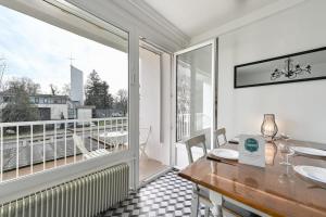 a dining room with a table and a large window at Le Boileau - Apartment for 4 people parking and balcony CLOSE to the Lake in Annecy