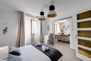 a bedroom with a bed and a living room at Les Capucins - 3 bedroom apartment near the city in Annecy