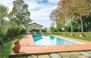 a swimming pool in a yard with a brick patio at Villa Di Collina in Vicchio