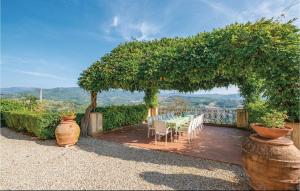 a patio with a table and chairs under a pergola at Villa Di Collina in Vicchio +25 photos