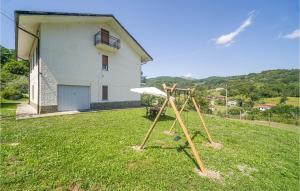 a swing set in a yard in front of a house at Nice Home In San Pietro Vara -Sp- in San Pietro Vara