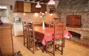 a kitchen with a table and a stone fireplace at 2 Bedroom Beautiful Home In Geffosses in Geffosses
