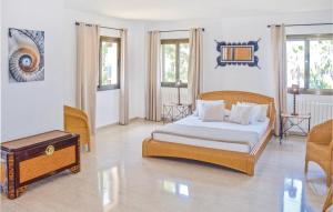 a bedroom with a bed and a table at Stunning Home In Bahia Azul-Badia Blava in Badia Blava