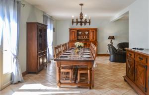 a dining room with a wooden table and chairs at Lovely Home In Savignac-Ledrier in Payzac