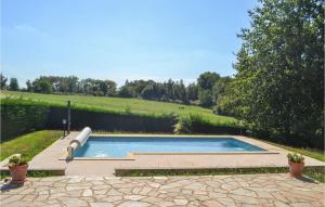 a swimming pool with a slide in a yard at Lovely Home In Savignac-Ledrier in Payzac