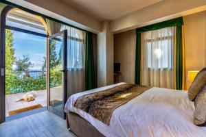 a bedroom with a bed and a sliding glass door at Baba Residences in Alassio +153 photos