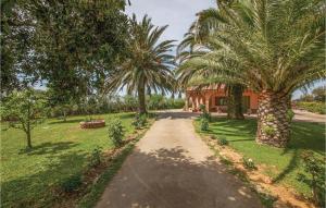a path in a park with palm trees at Beautiful Apartment In Cecina Li With 2 Bedrooms in Fiorino