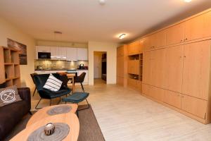 a living room with a couch and a table at Haus "Panorama" Appartement PAN068 in Duhnen