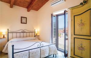 a bedroom with a bed and a glass door at Villa Marisa in Perdifumo