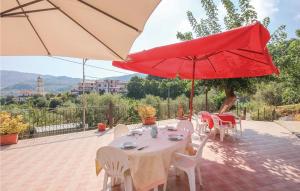 a patio with a table and two umbrellas at Villa Marisa in Perdifumo +9 photos