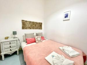 a small bedroom with a bed and a night stand at Apartments Center Castelo de São Jorge I in Lisbon