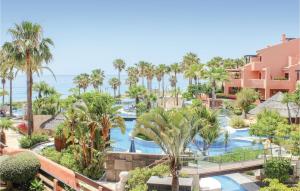 an aerial view of a resort with a pool and palm trees at Awesome Apartment In Estepona With 1 Bedrooms, Outdoor Swimming Pool And Swimming Pool in Estepona