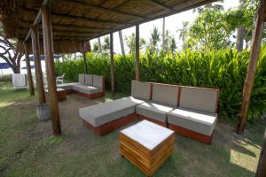 a group of couches and tables under a gazebo at Baía Branca Beach Resort in Tamandaré