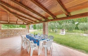 a blue table and chairs under a wooden ceiling at Villa Il Casale in Sperlonga