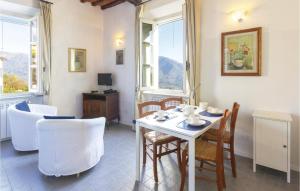 a dining room with a table and chairs and windows at Il Ghiro in Camaiore