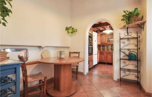a kitchen with a wooden table in a room at Beautiful Home In St Paul En Foret in Saint-Paul-en-Forêt