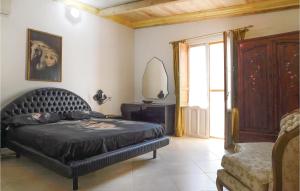 a bedroom with a bed and a mirror and a window at Villa Gladiolo in Marzamemi