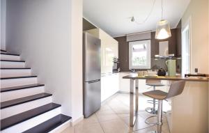 a kitchen with a staircase and a kitchen table with chairs at Cioso 15 in Cisano sul Neva