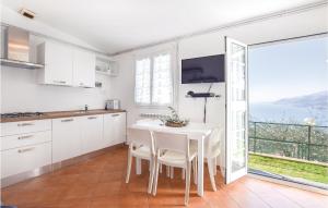 a kitchen with a table and a view of the ocean at Casa Morgana in Boschetto