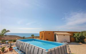 a swimming pool in front of a house at Baglio Mediterraneo in Borgo Bonsignore