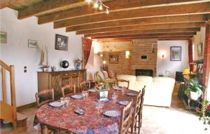 a dining room with a table and chairs and a couch at Beautiful Home In Clohars Carnoet in Clohars-Carnoët +19 photos