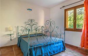 a metal bed in a room with a window at Trilo 6 in Budoni