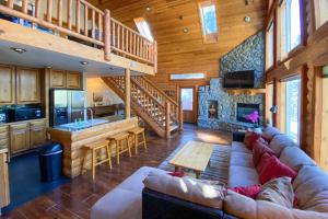 a living room with a large couch in a cabin at Home with Indoor Pool in South Lake Tahoe! in South Lake Tahoe