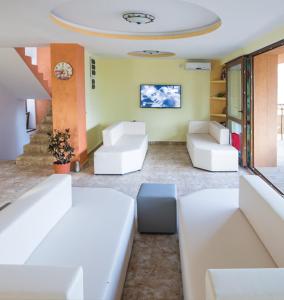 a living room with white furniture and a ceiling at Rosiem House in Techirghiol