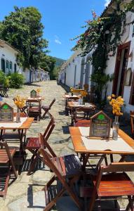 a group of tables and chairs on a street at Casa em Paraty in Paraty