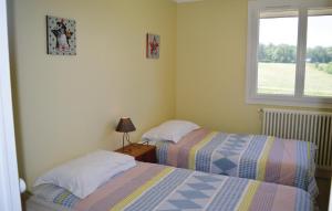 two beds in a small room with a window at Beautiful Home In Eyliac in Saint-Laurent-sur-Manoire