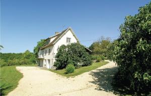 a white house with a dirt road in front of it at Beautiful Home In Eyliac in Saint-Laurent-sur-Manoire