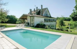 a large swimming pool in front of a house at Beautiful Home In Eyliac in Saint-Laurent-sur-Manoire