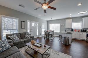 a living room with a couch and a ceiling fan at T-Town Cottage in Tuscaloosa