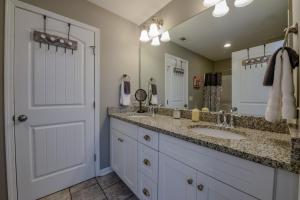 a bathroom with two sinks and a large mirror at T-Town Cottage in Tuscaloosa +31 photos