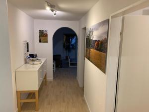 a hallway with a desk and paintings on the walls at Dokazien in Waldems