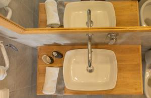 a bathroom with a sink and two toilets at Fragoulis Village in Parasporos