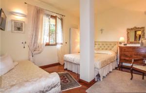 a bedroom with two beds and a dresser and a mirror at La Perla in Castiglione Chiavarese