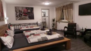 a living room with two beds and a couch at Gästehaus Metropolitan in Rust