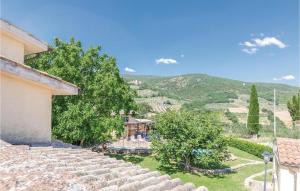 a view of a house with mountains in the background at Pet Friendly Apartment in Giano dellʼUmbria