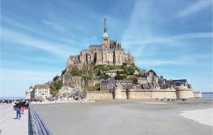 a castle on top of a mountain on a beach at Gorgeous Apartment In Vildé-La-Marine in Vildé la Marine