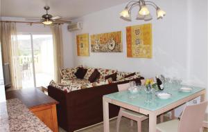 a living room with a couch and a table at Cozy Apartment In Isla Plana in Isla Plana
