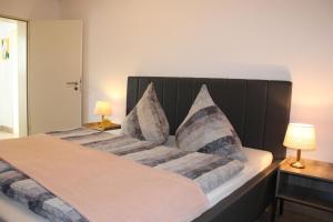a bedroom with a large bed with two pillows at Ferienwohnung Am Eifelsteig, Golbach in Kall