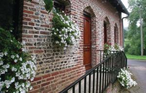 a brick building with a door with flowers on it at 2 Bedroom Beautiful Home In Embry in Embry