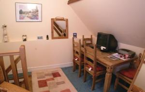 a dining room with a table with chairs and a television at Amazing Home In Embry With Wifi in Embry