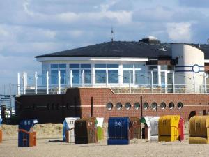 a building with a lot of suitcases in front of it at Doppelhaushälfte in Neßmersiel in Neßmersiel +9 photos